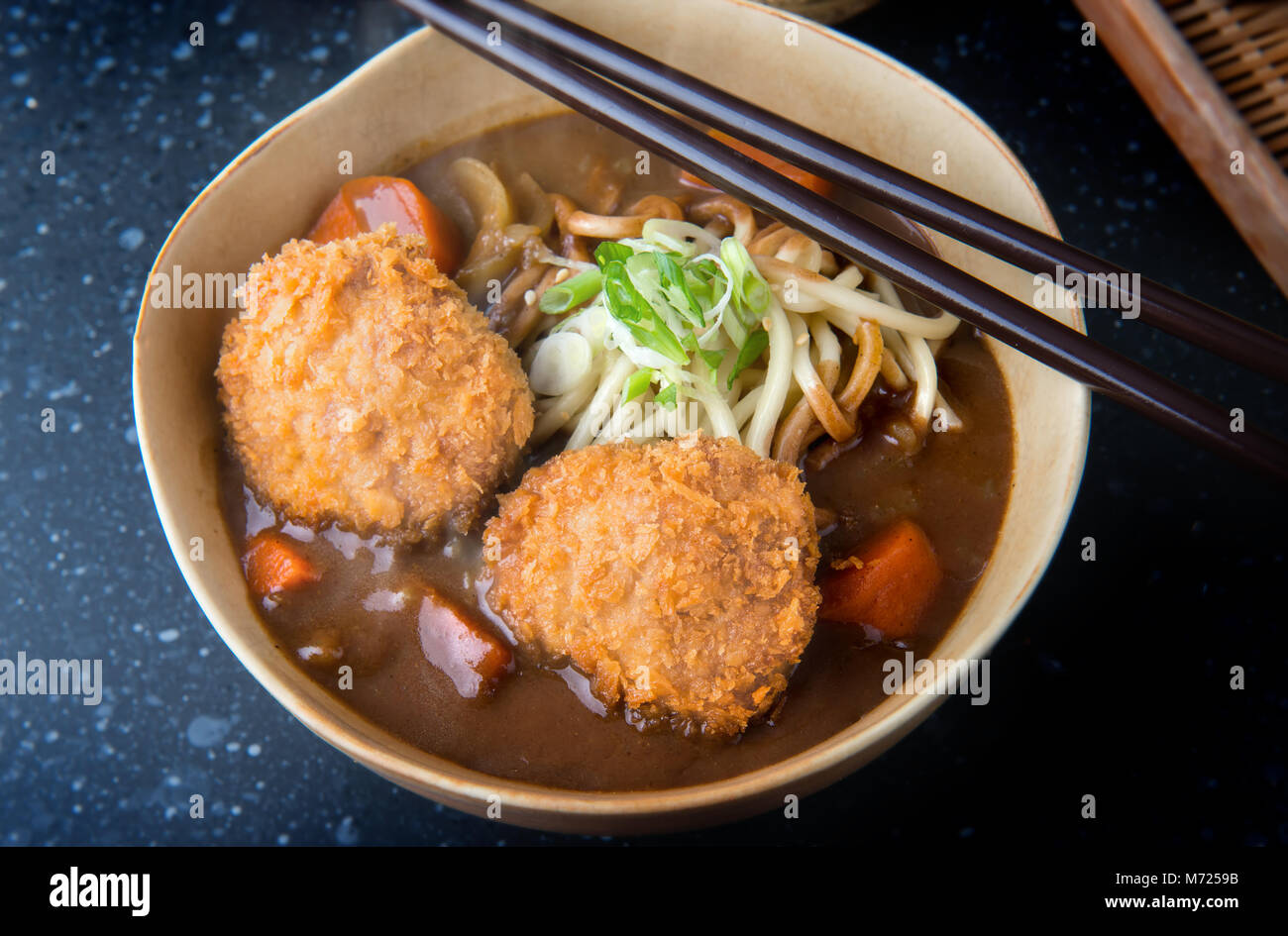 Japanese curry with udon noodle and crispy pork chop croquettes topping