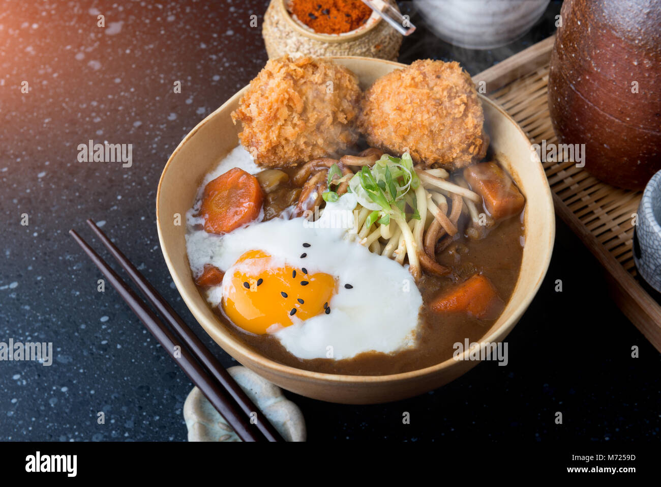 Japanese curry with udon noodle and crispy pork chop croquettes and