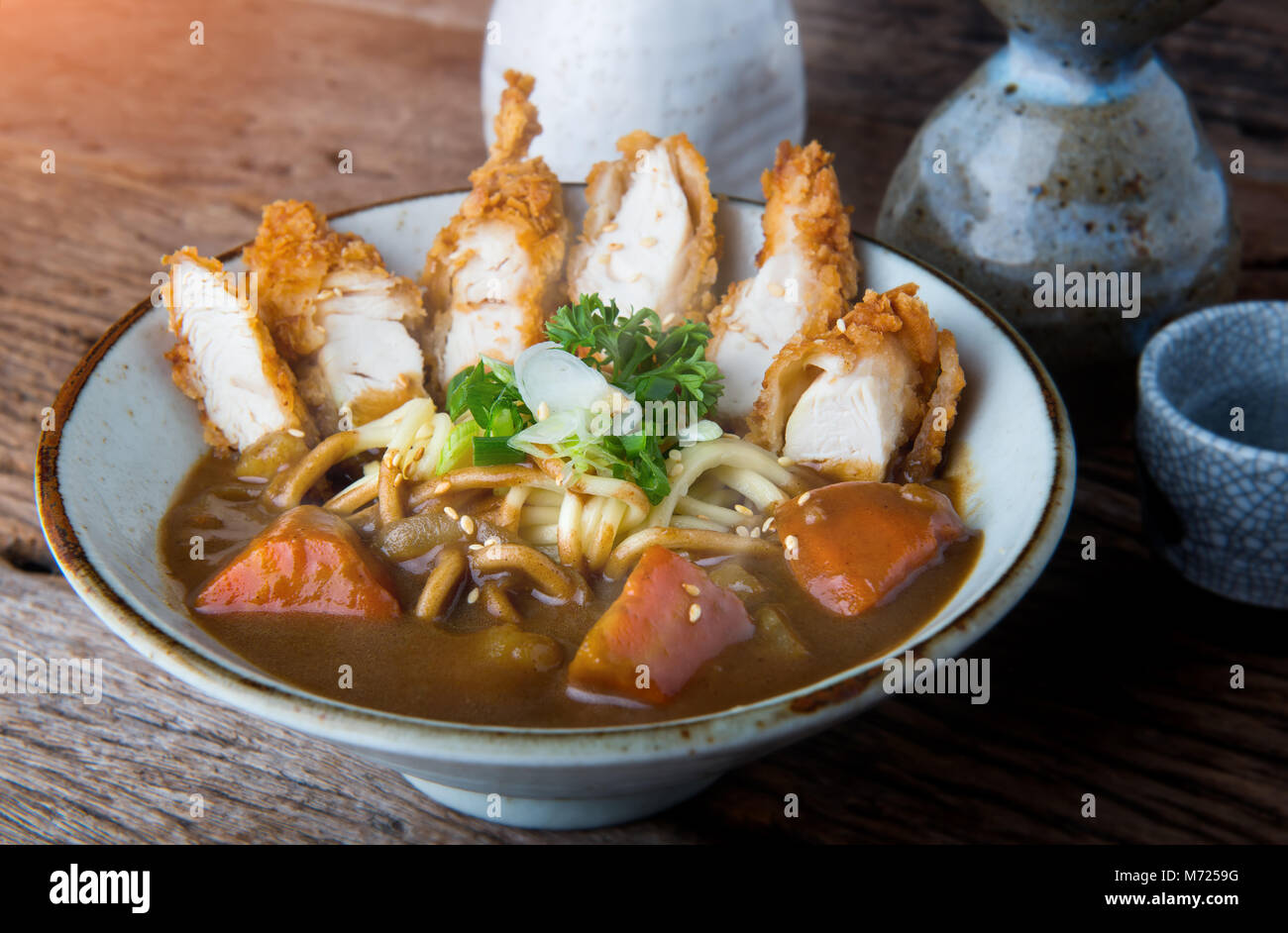 Japanese curry with udon noodle and crispy chicken tenderloid in bowl