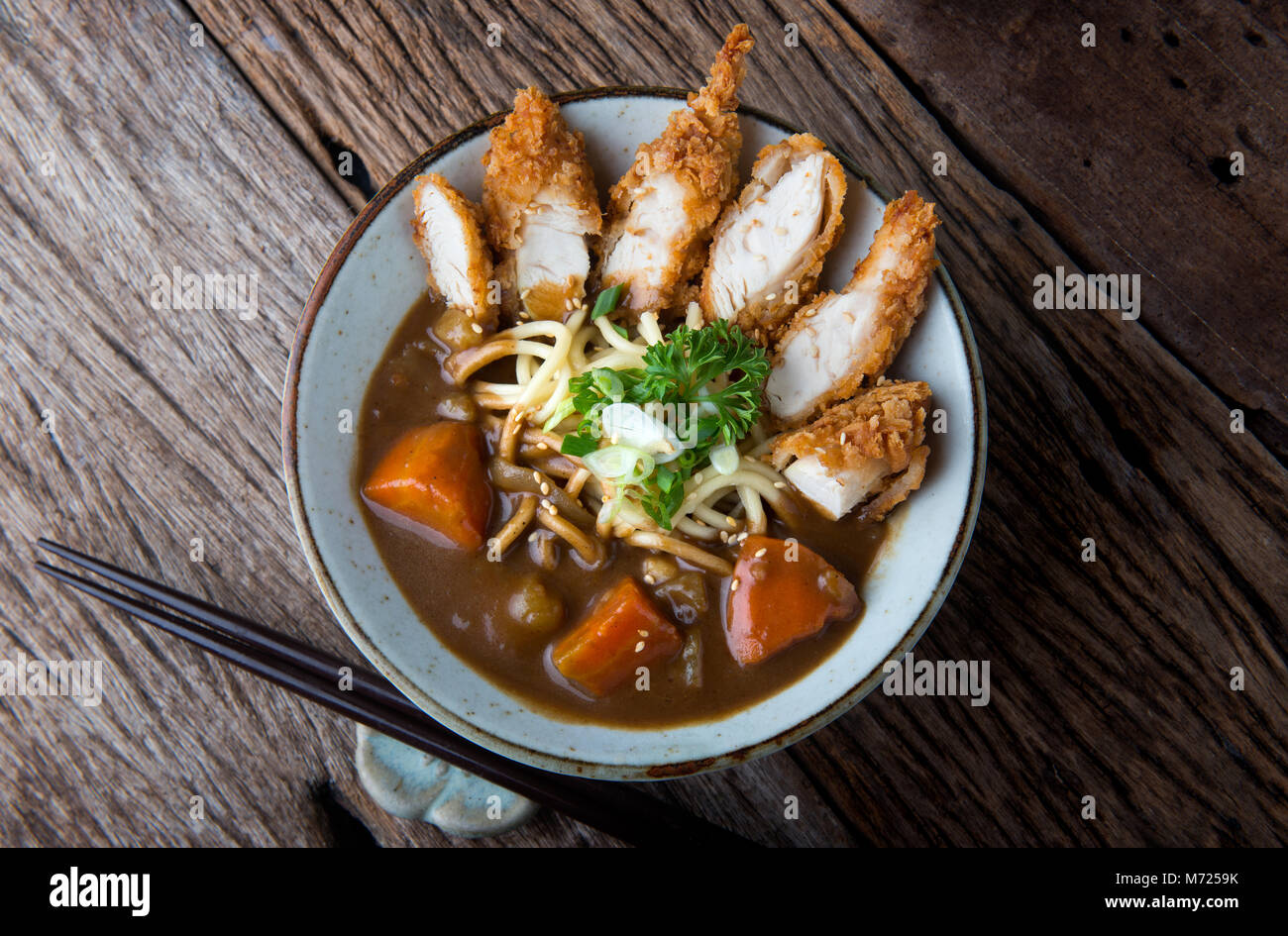 Japanese curry with udon noodle and crispy chicken tenderloid in bowl