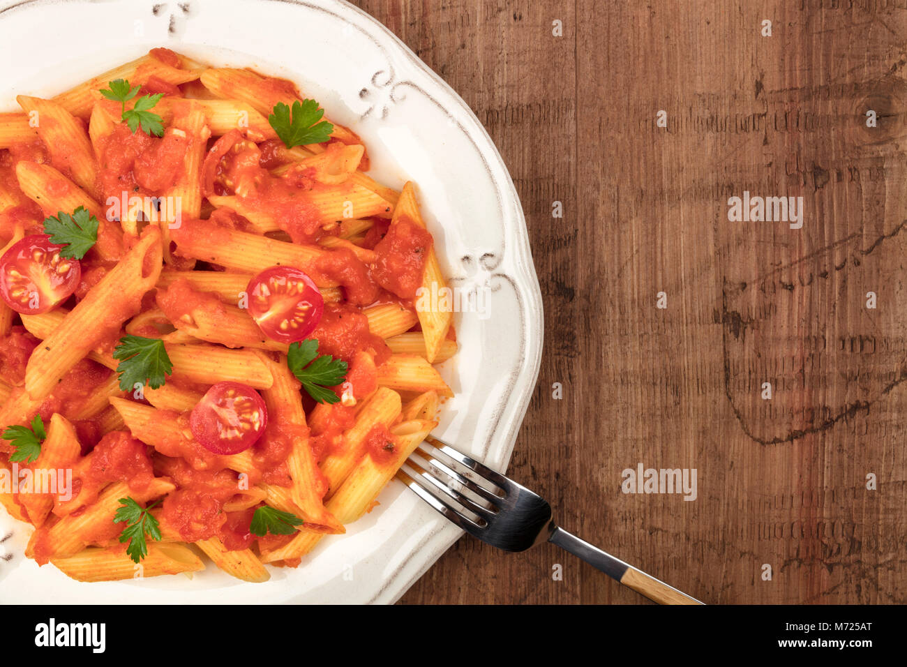 Penne pasta closeup with tomato sauce and place for text Stock Photo