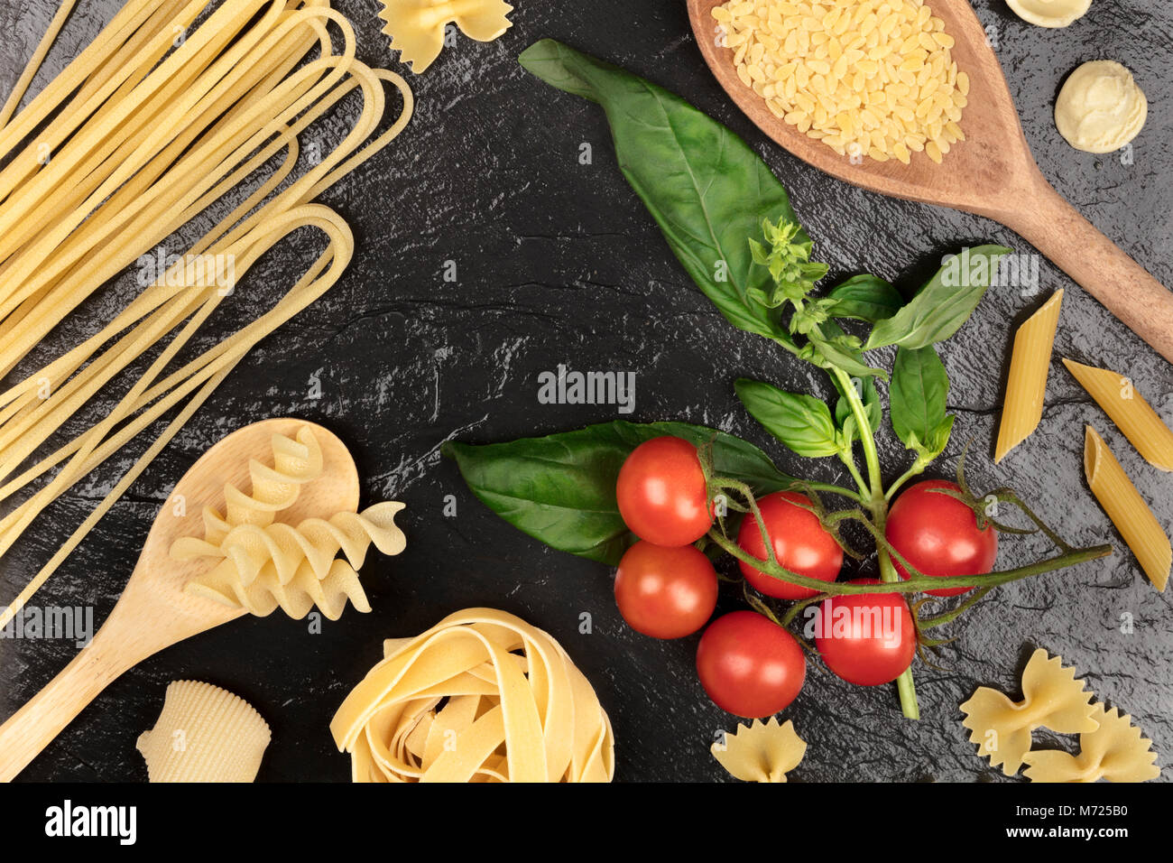 Overhead photo of different types of pasta with cherry tomatoes and ...