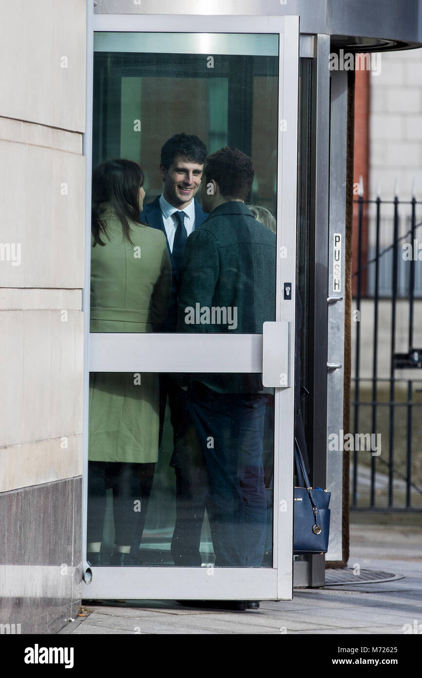 Blane McIlroy (centre) interacts with Ireland and Ulster rugby player Paddy Jackson (right) as they meet while queuing to enter Belfast Crown Court, where Mr McIlroy is on trial accused of one count of exposure, and Mr Jackson with his teammate Stuart Olding are on trial accused of raping a woman at a property in south Belfast in June 2016. Stock Photo