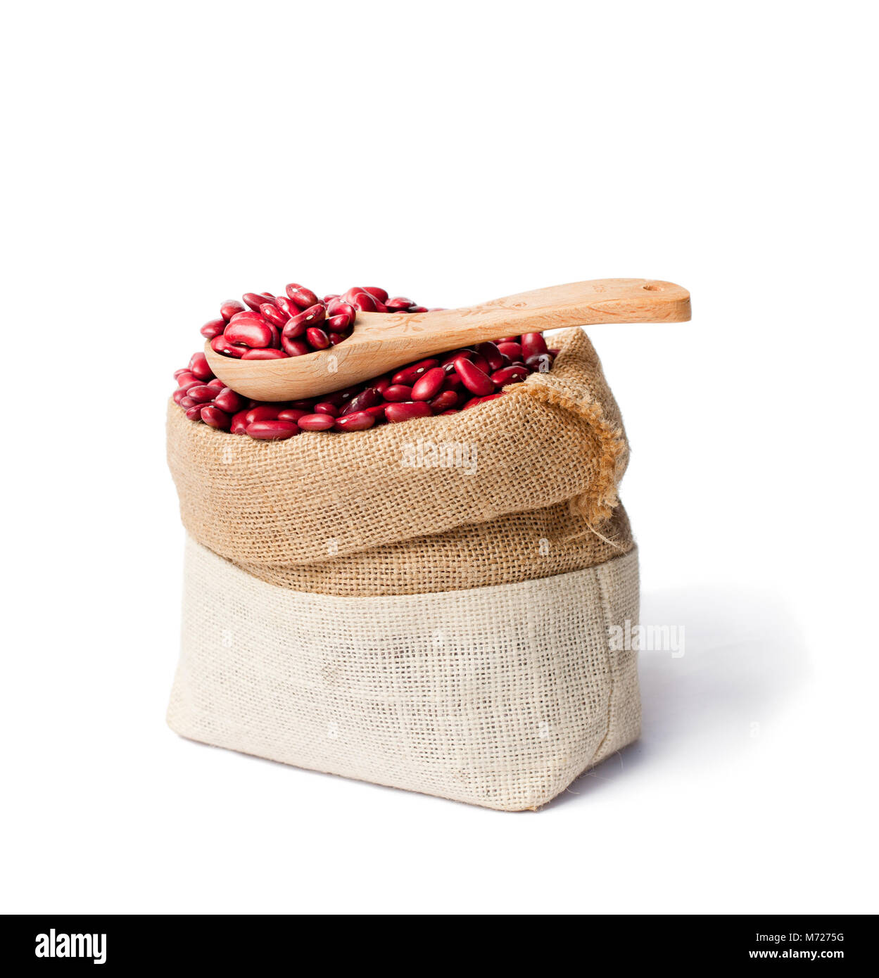 red  kidney beans in the sackcloth bag with wooden spoon isolated Stock Photo