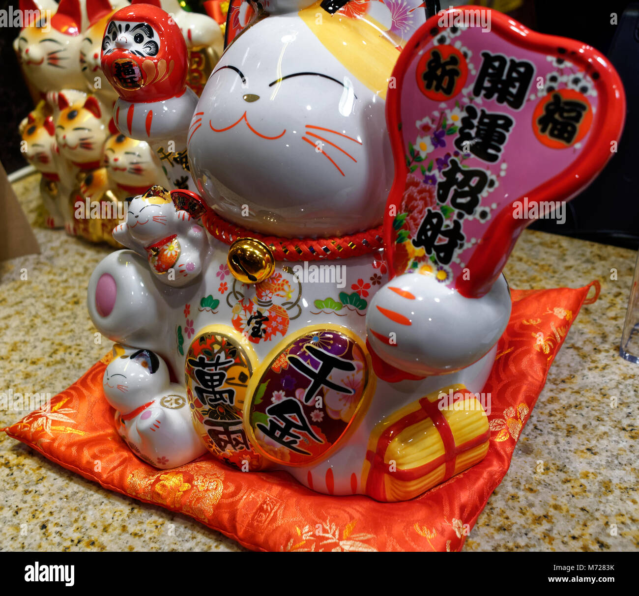 Maneki Neko lucky fortune cats on display at a restaurant Stock Photo