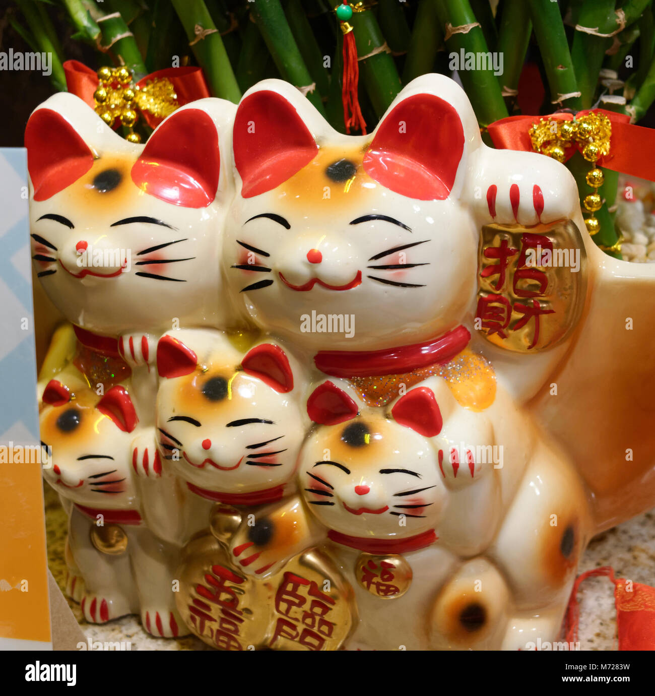 Maneki Neko lucky fortune cats on display at a restaurant Stock Photo