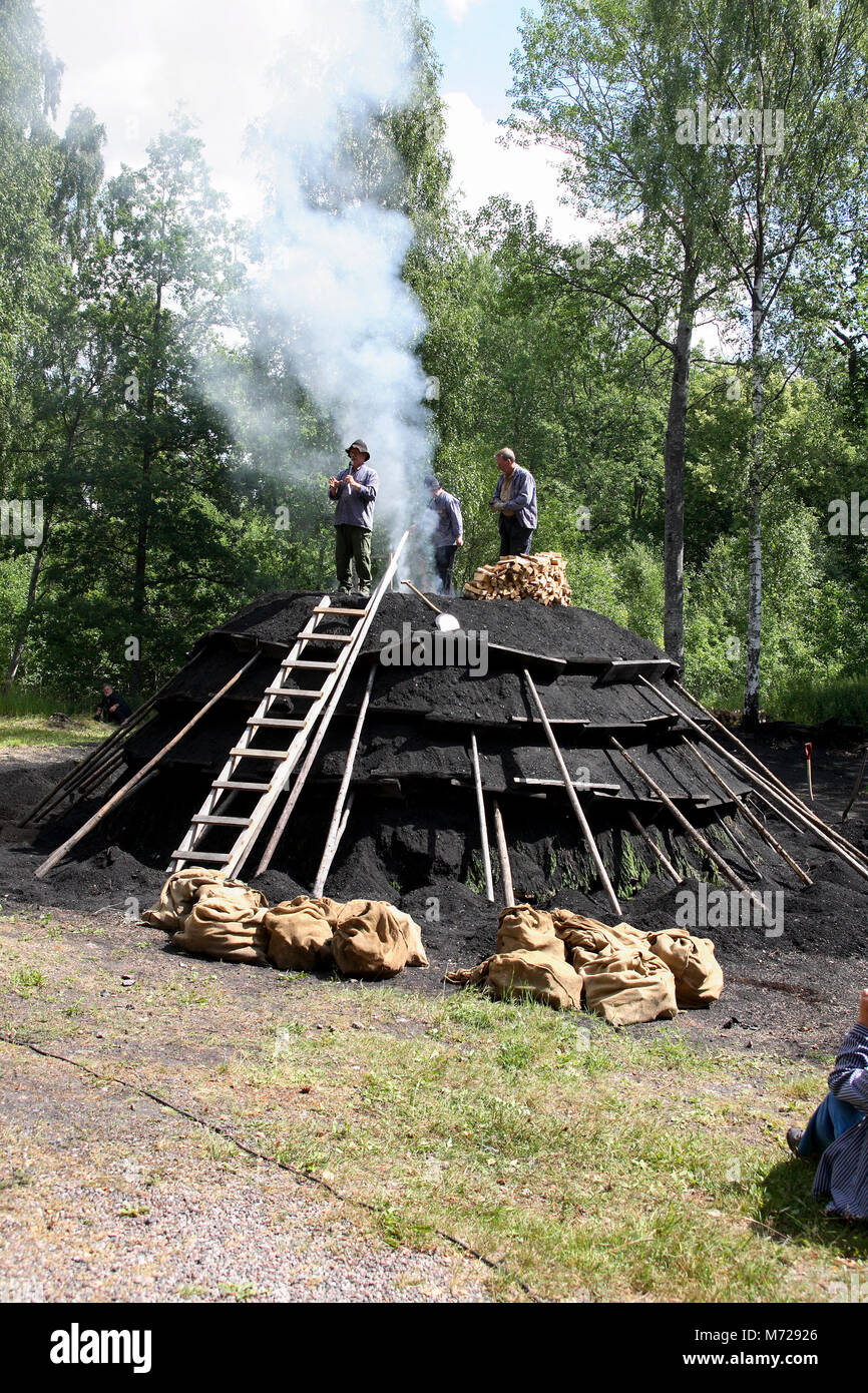 CHARCOAL BURNERS start a Charcoal stack Stock Photo Alamy