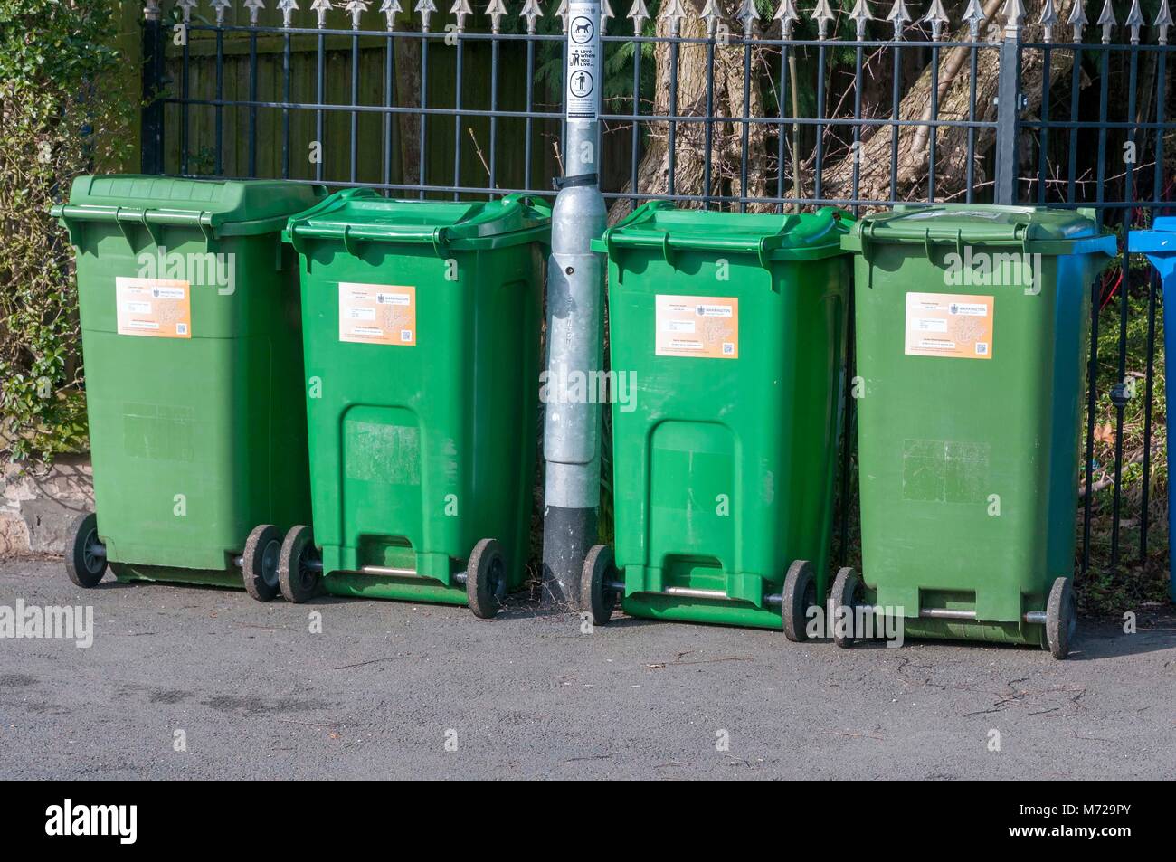 Four 4 green garden waste recycling bins Stock Photo Alamy