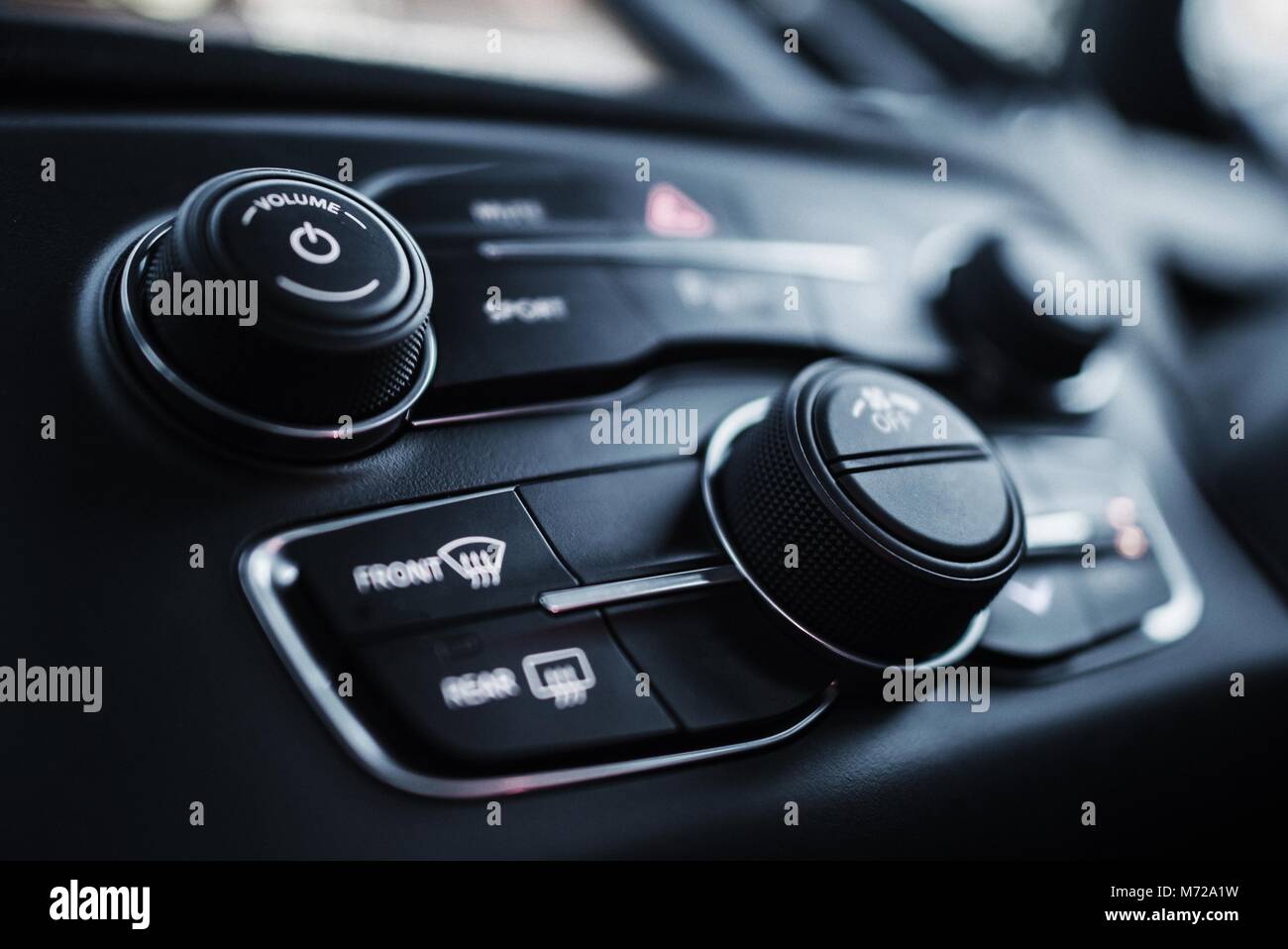 Car Dashboard Instruments Closeup Photo. Multimedia and Climate Control Buttons. Stock Photo