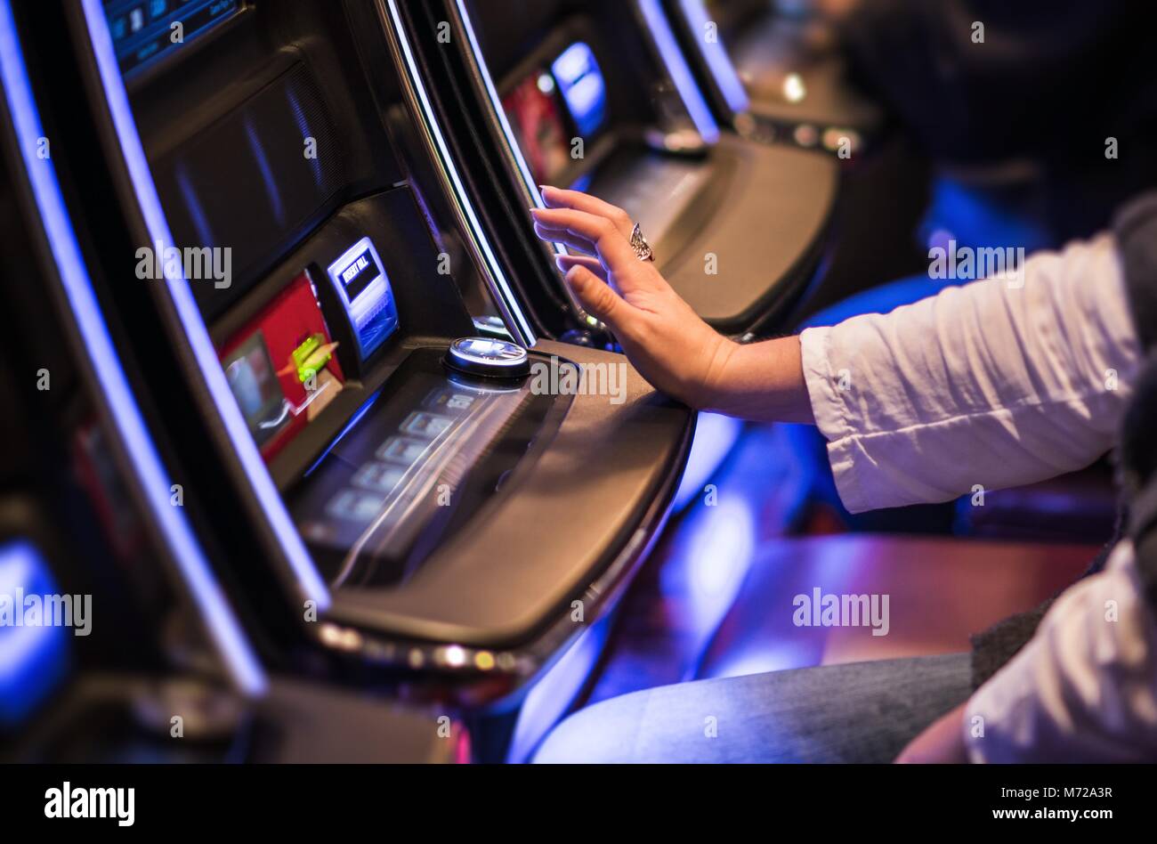 Casino Video Slots Game Playing. Caucasian Woman Feeling Lucky in the Vegas Casino. Stock Photo