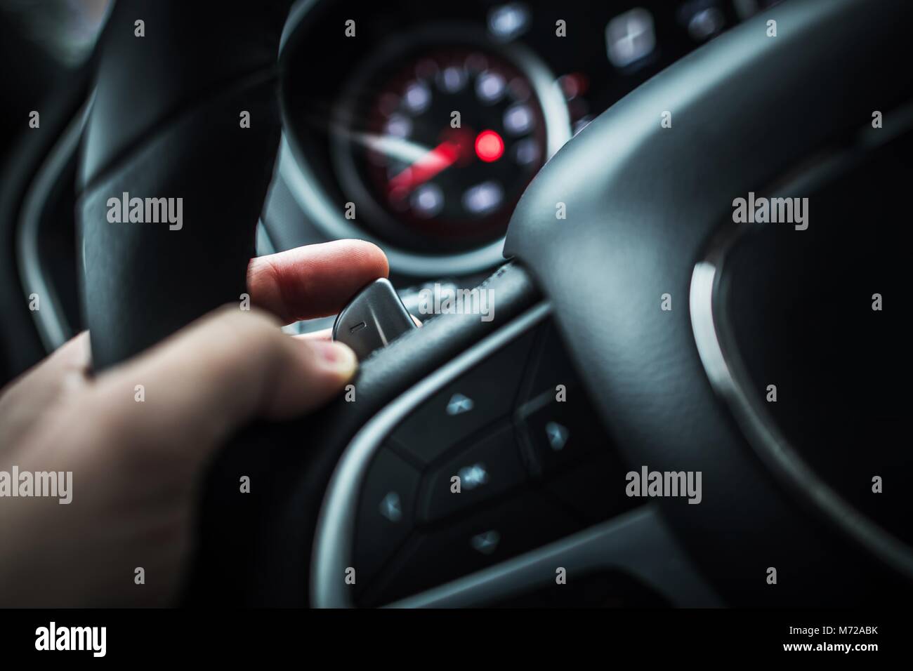 Automatic Transmission Paddle Shift Driving Concept. Caucasian Driver Hand  on the Left Side Steering Wheel Shifter Stock Photo - Alamy
