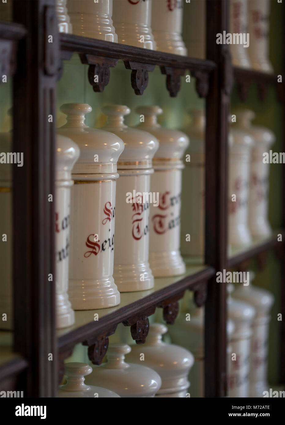 Apothecary shelves with many ceramic jars of medicines with Gothic