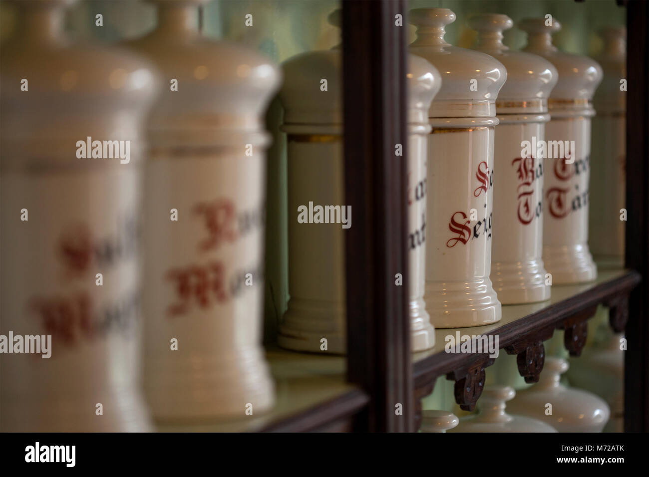Apothecary shelves with many ceramic jars of medicines with Gothic