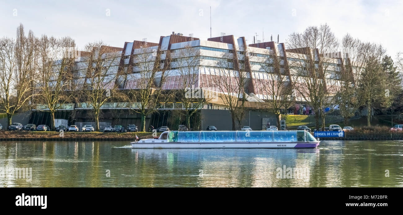 Back of the Council of Europe building with a tourist boat in the foreground touring on the Ill river, Strasbourg, France. Stock Photo
