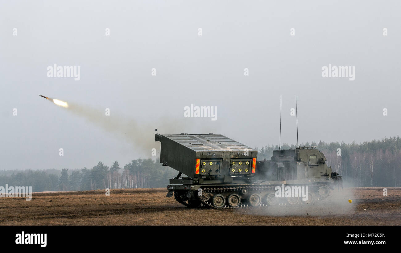 British soldiers from 176th Battery, 19th Regiment Royal Artillery, conduct live fire training using the multiple launch rocket system during Dynamic Front 18 in Grafenwoehr, Germany, March 7, 2018. Exercise Dynamic Front 18 includes approximately 3,700 participants from 26 nations training together from Feb. 23-March 10, 2018. Dynamic Front is an annual U.S. Army Europe (USAREUR) exercise focused on the interoperability of U.S. Army, joint service and allied nation artillery and fire support in a multinational environment, from theater-level headquarters identifying targets to gun crews pulli Stock Photo