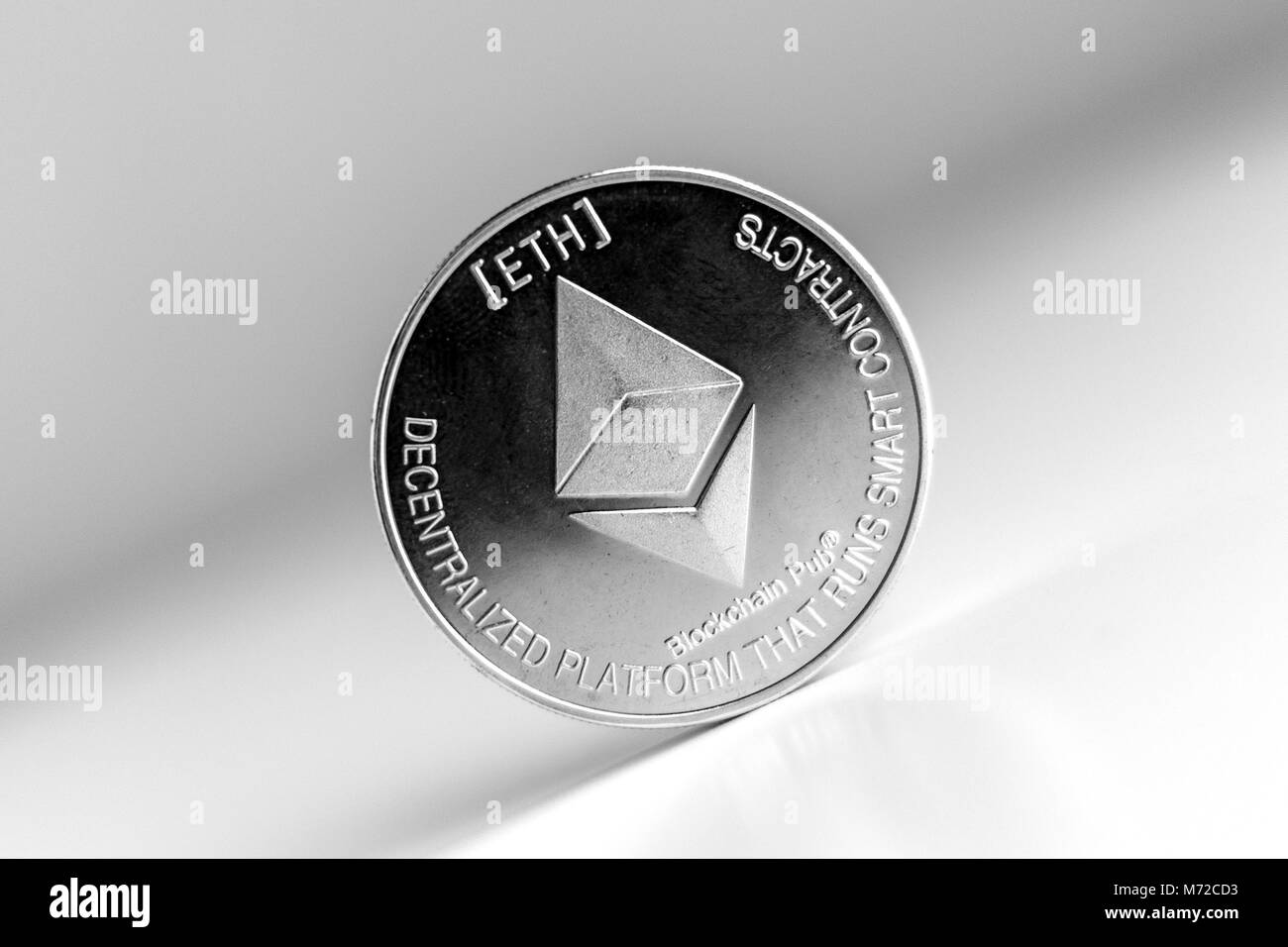 Single ethereum coin on the surface cryptocurrency isolated Stock Photo