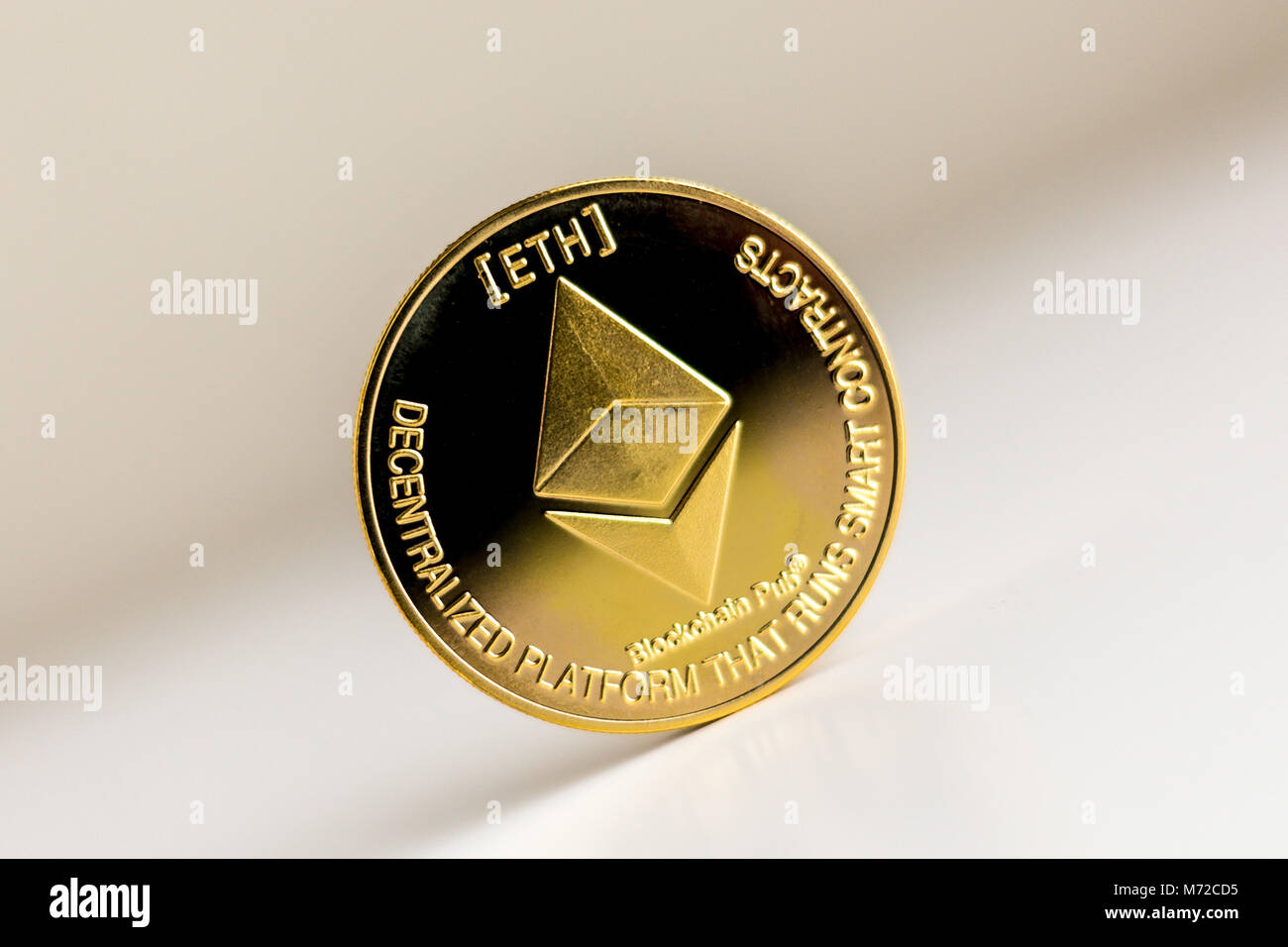 Single ethereum coin on the surface cryptocurrency isolated Stock Photo