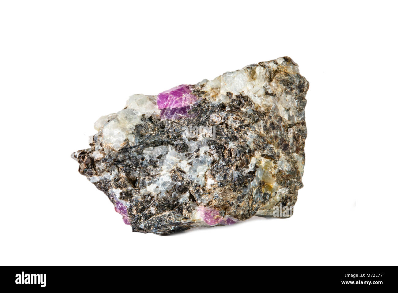 Macro shooting of natural gemstone. Raw mineral ruby in albite. Karelia. Isolated object on a white background. Stock Photo