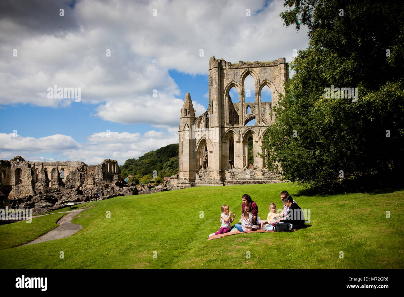 Picnic on a summer at Rievaulx Abbey the first Cistercian monastery in the north of England, the remains are a tourist attraction of English Heritage. Stock Photo