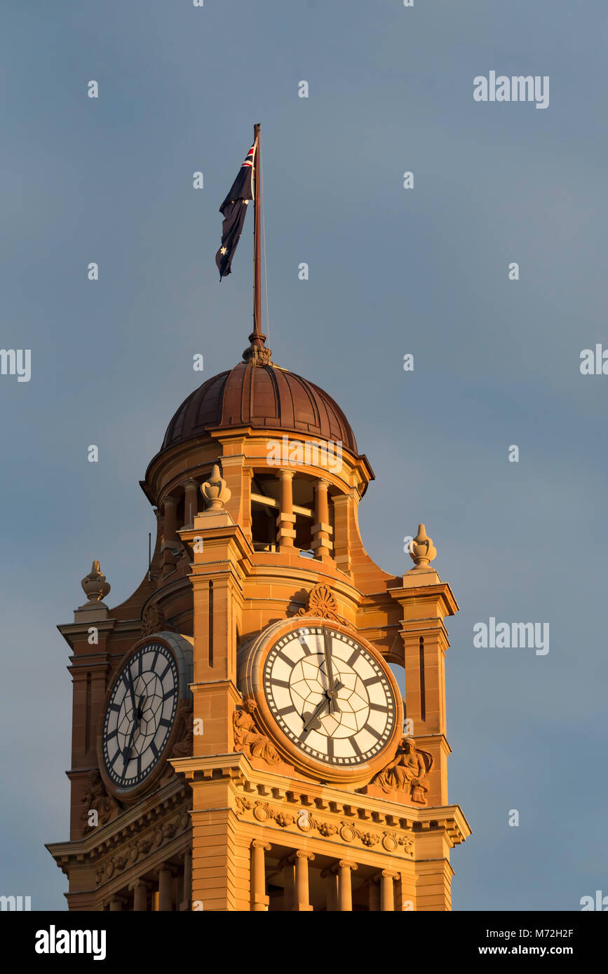 The clock tower with its bronze dome and Australian flag atop bathes in