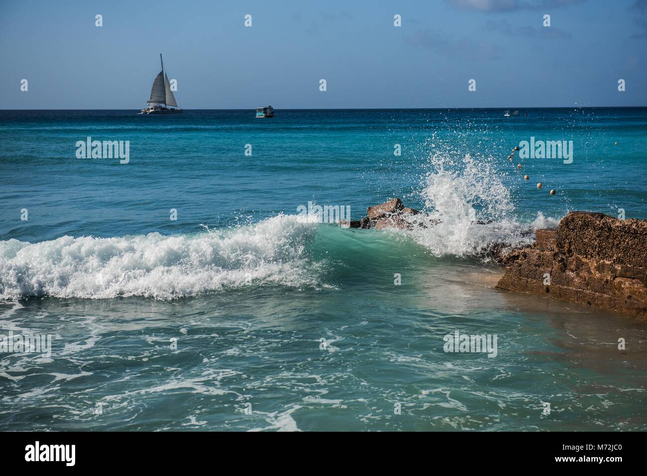 Waves on the beach, St James, Barbados Stock Photo