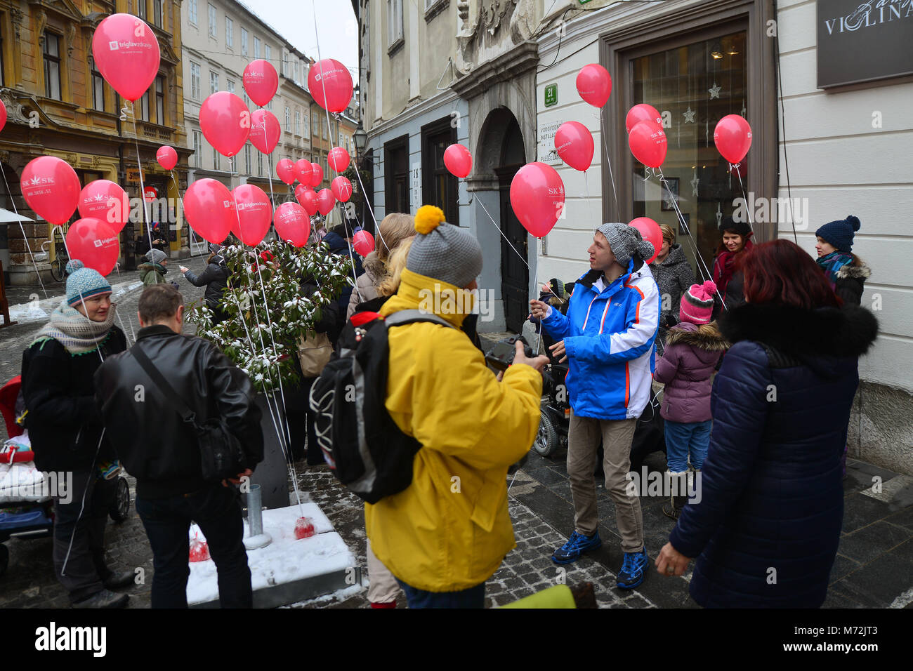 Ljubljana, Slovenia on MARCH 3., 2017. People at all-Slovenian hike with red balloons at the international Rare Disease Day Stock Photo