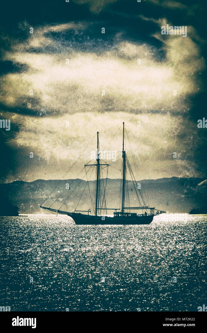 Old wooden ship in the sea under a dramatic sky.Fine art image canvas texture added. Stock Photo