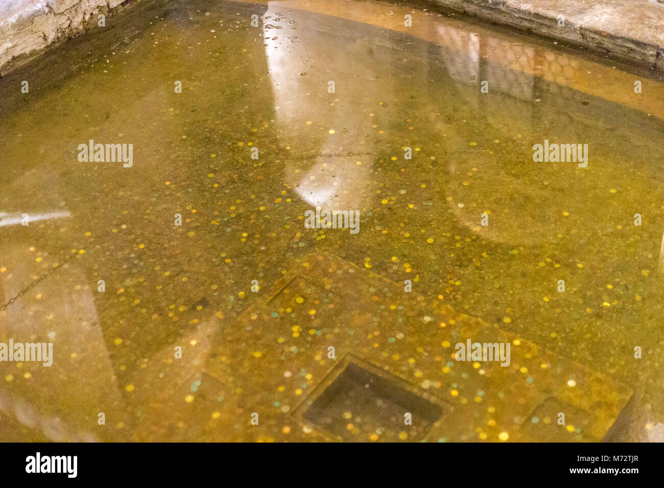 Coins thrown into the water as a superstitious gesture to ask wishes or luck Stock Photo