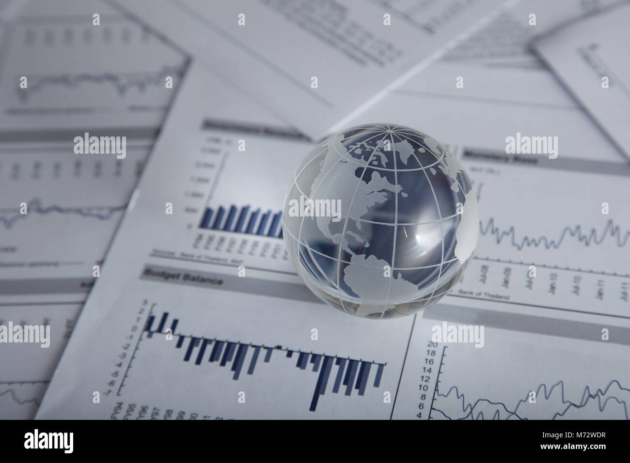 Glass globe on the chart papers Stock Photo - Alamy