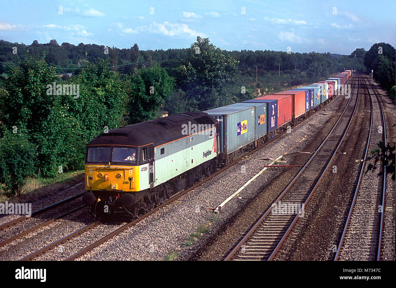 A class 47 diesel locomotive number 47289 working a freightliner service at Lower Basildon on the Great Western main line. 21st August 2002. Stock Photo