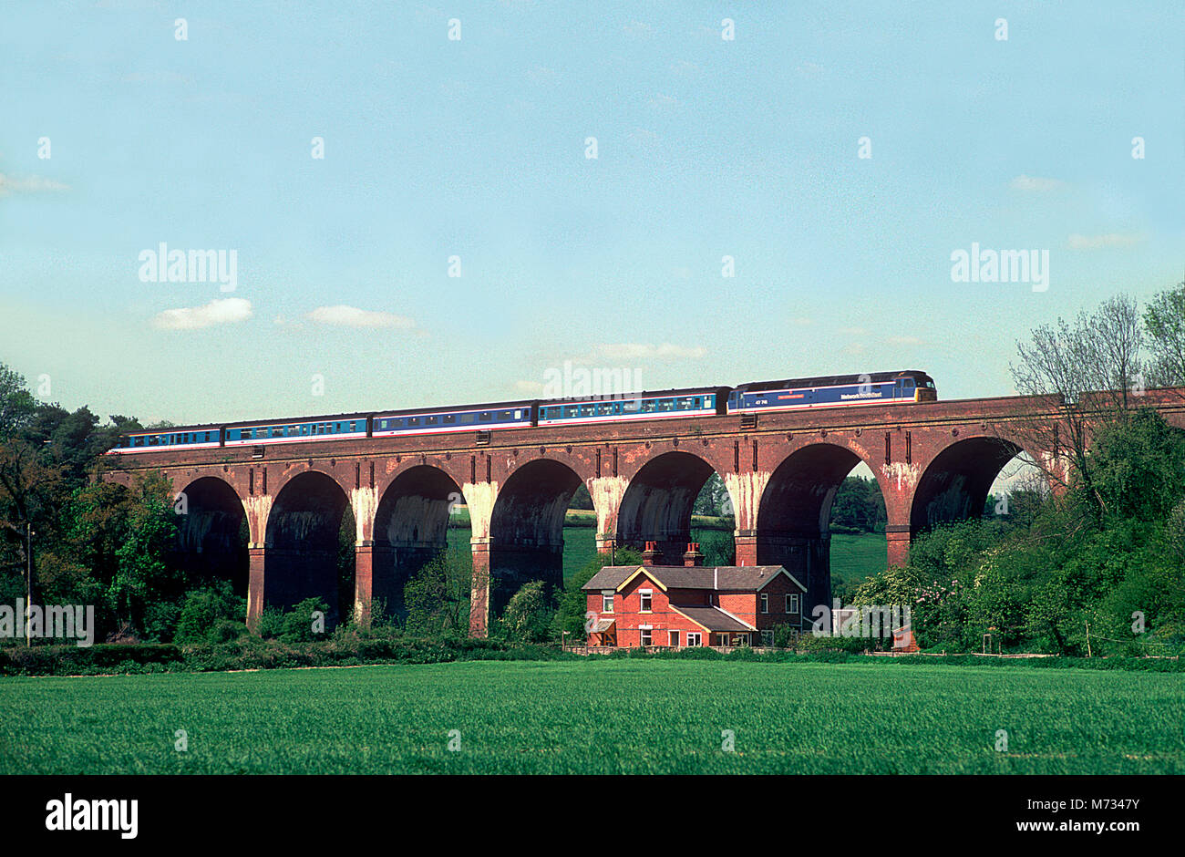 A class 47 diesel locomotive number 47716 'Duke of Edinburgh's Award' working a Network SouthEast west of England service over Hurstbourne Viaduct on the 6th May 1993. Stock Photo