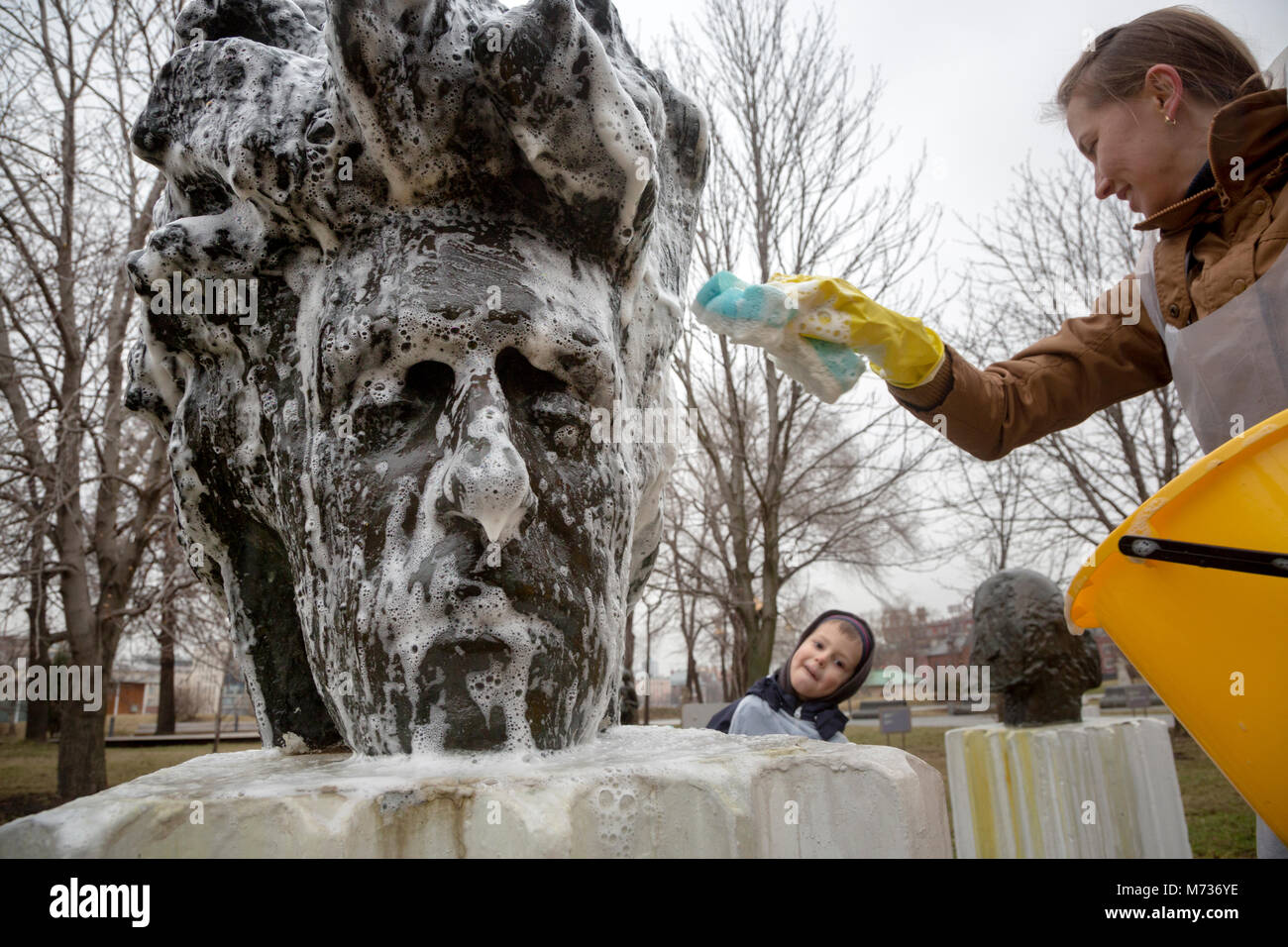 A woman washes a sculpture during annual spring event (Subbotnik) in Moscow's Muzeon Park of Arts ,Russia Stock Photo