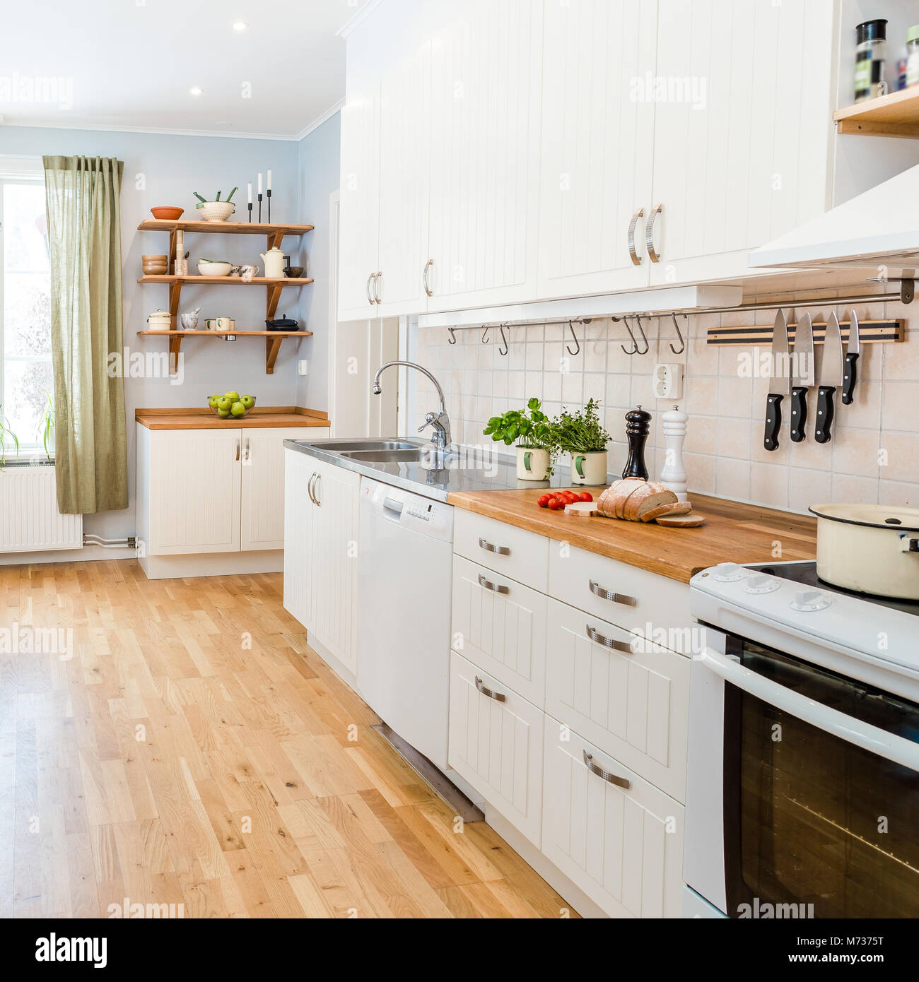 Modern stylish Scandinavian kitchen interior with kitchen accessories.  Bright white and grey kitchen with household items in studio apartment  Stock Photo - Alamy