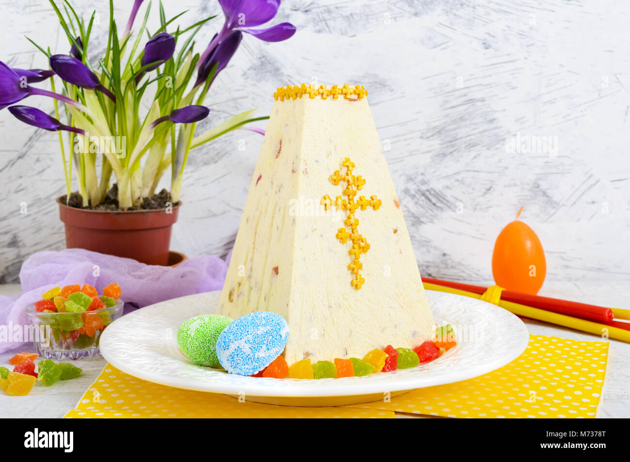 Traditional curd Easter cake with candied fruits and spring flowers