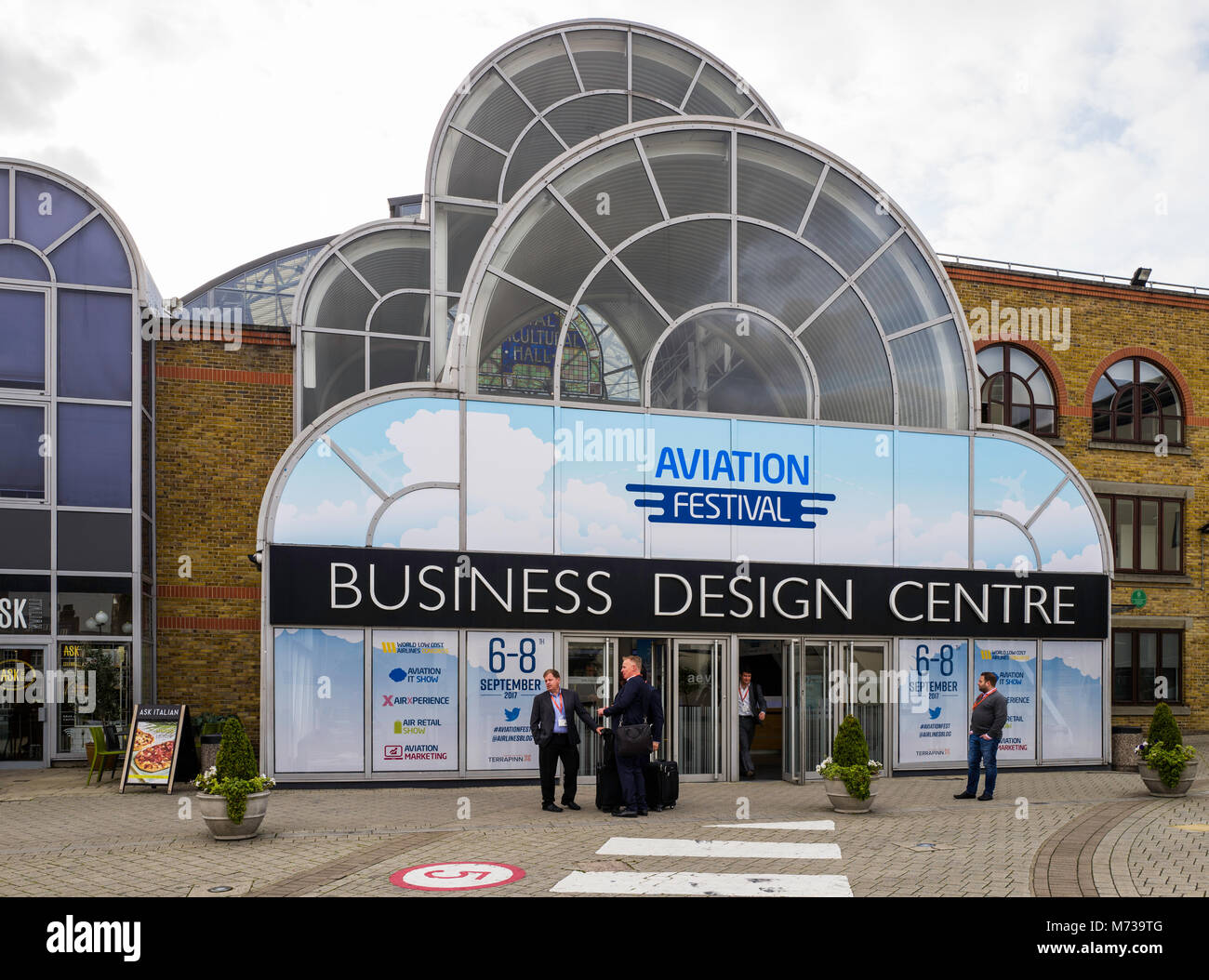 Businessmen await taxis outside the 'Aviation Festival' at London's Business Design Centre in Islington.  September 2017. Stock Photo