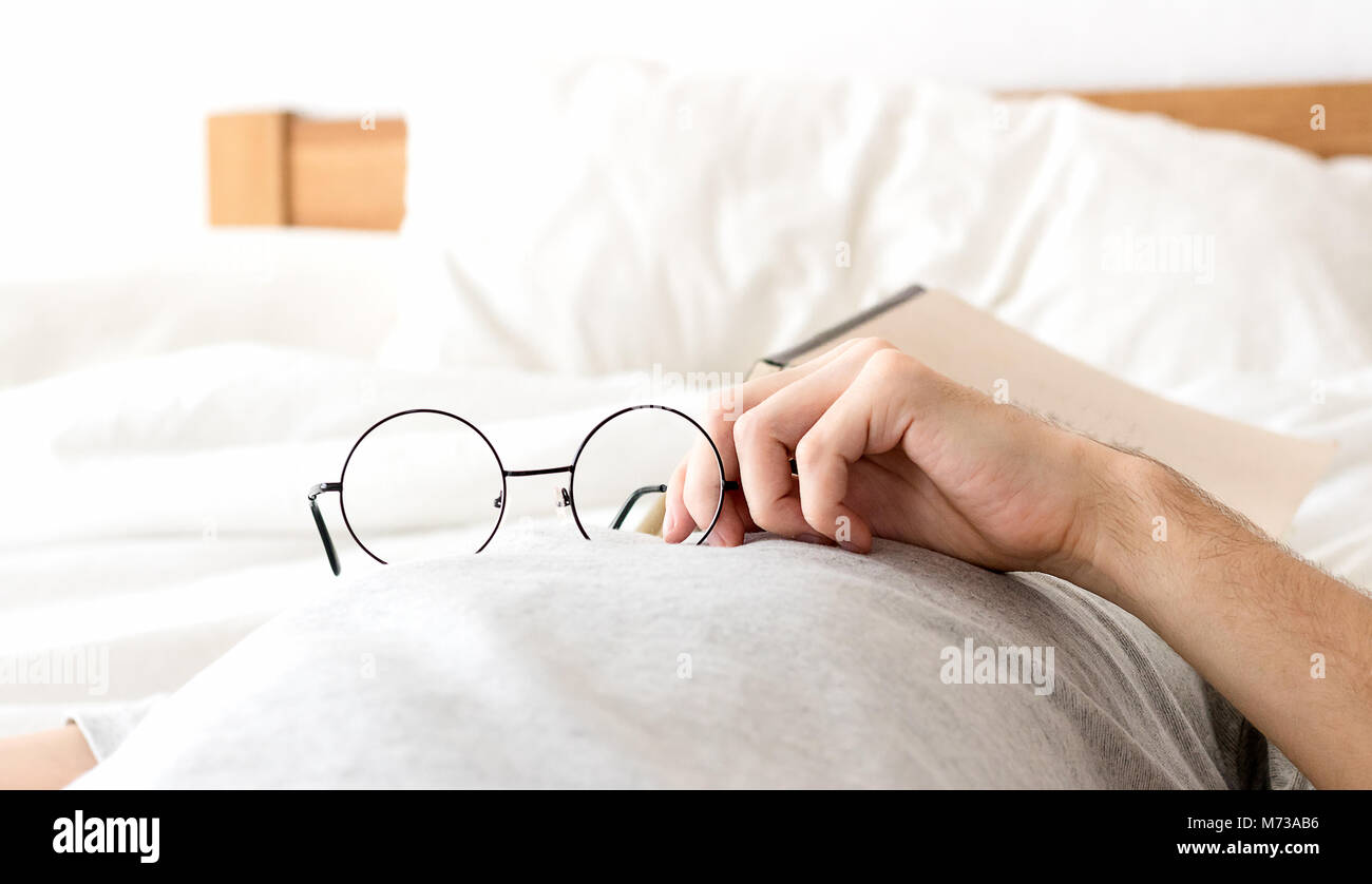 Men hold glasses sleep no bed with after reading Stock Photo Alamy