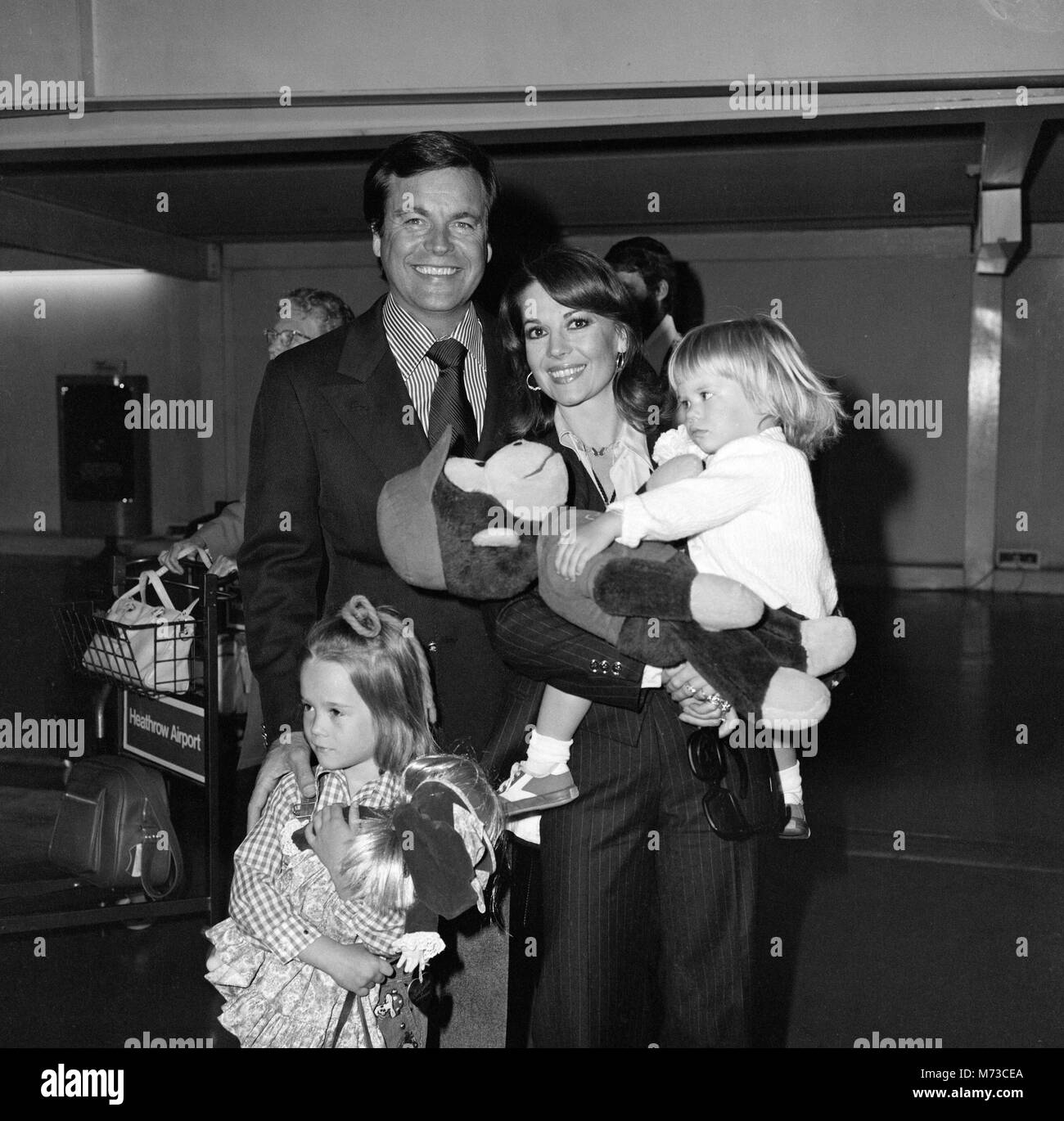 Film actor Robert Wagner and his wife Natalie Wood arrived at Heathrow Airport from Los Angeles with their children Courtney (2) and Natasha (5). Courtney was carrying a doll called 'Curious George.' They were met by Lord Olivier and are here to make a Granada TV production with him of 'Cat on a Hot Tin Roof .' 19th May 1976. Stock Photo