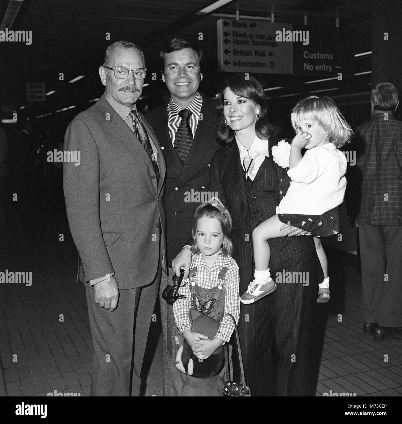Film actor Robert Wagner and his wife Natalie Wood arrived at Heathrow Airport from Los Angeles with their children Courtney (2) and Natasha (5). Courtney was carrying a doll called 'Curious George.' They were met by Lord Olivier and are here to make a Granada TV production with him of 'Cat on a Hot Tin Roof .' 19th May 1976. Stock Photo