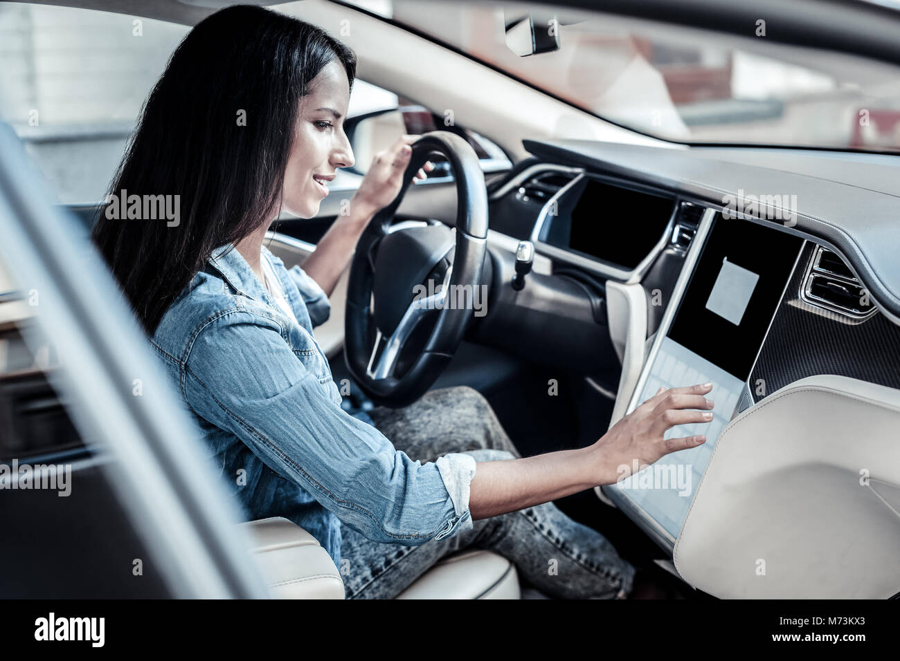 Nice young woman sitting behind the wheel Stock Photo - Alamy