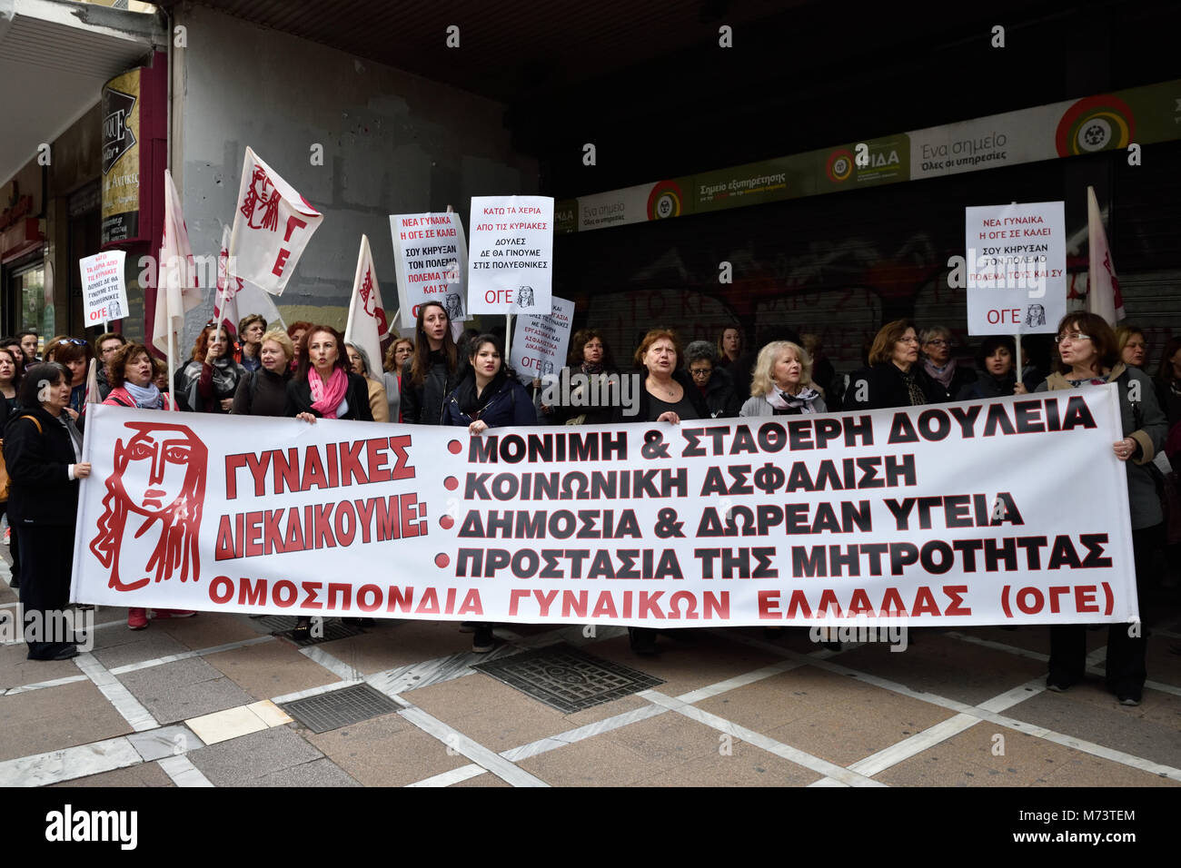 Athens, Greece, 8th March, 2018. Women holding placards and a banner that reads 'Women we claim: permanent and stable job, social insurance, public and free healthcare, protection of maternity' stand in front of the Ministry of Labor to honor the International Women's Day  in Athens, Greece. Credit: Nicolas Koutsokostas/Alamy Live News. Stock Photo