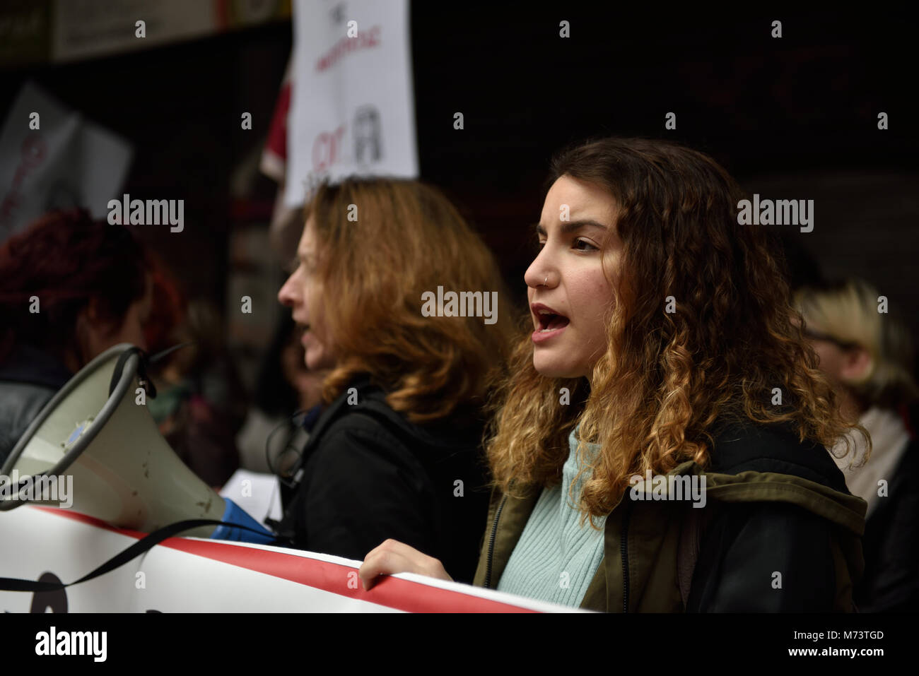 Athens, Greece, 8th March, 2018. A woman chants slogans standing in front of the Ministry of Labor to honor the International Women's Day  in Athens, Greece. Credit: Nicolas Koutsokostas/Alamy Live News. Stock Photo