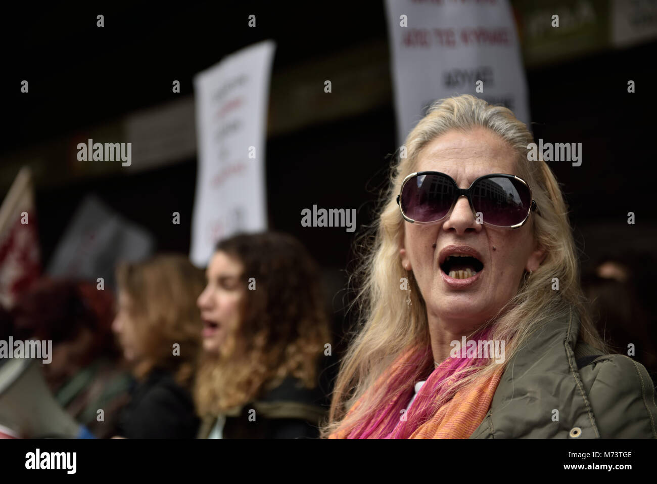 Athens, Greece, 8th March, 2018. A woman chants slogans standing in front of the Ministry of Labor to honor the International Women's Day  in Athens, Greece. Credit: Nicolas Koutsokostas/Alamy Live News. Stock Photo