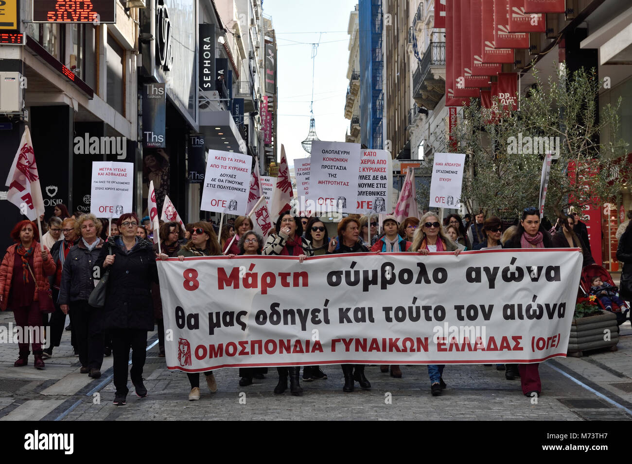 Athens, Greece, 8th March, 2018. Women holding placards and a banner that reads '8th March symbol of fight will lead us in this century also' march chanting slogans to honor the International Women's Day  in Athens, Greece. Credit: Nicolas Koutsokostas/Alamy Live News. Stock Photo