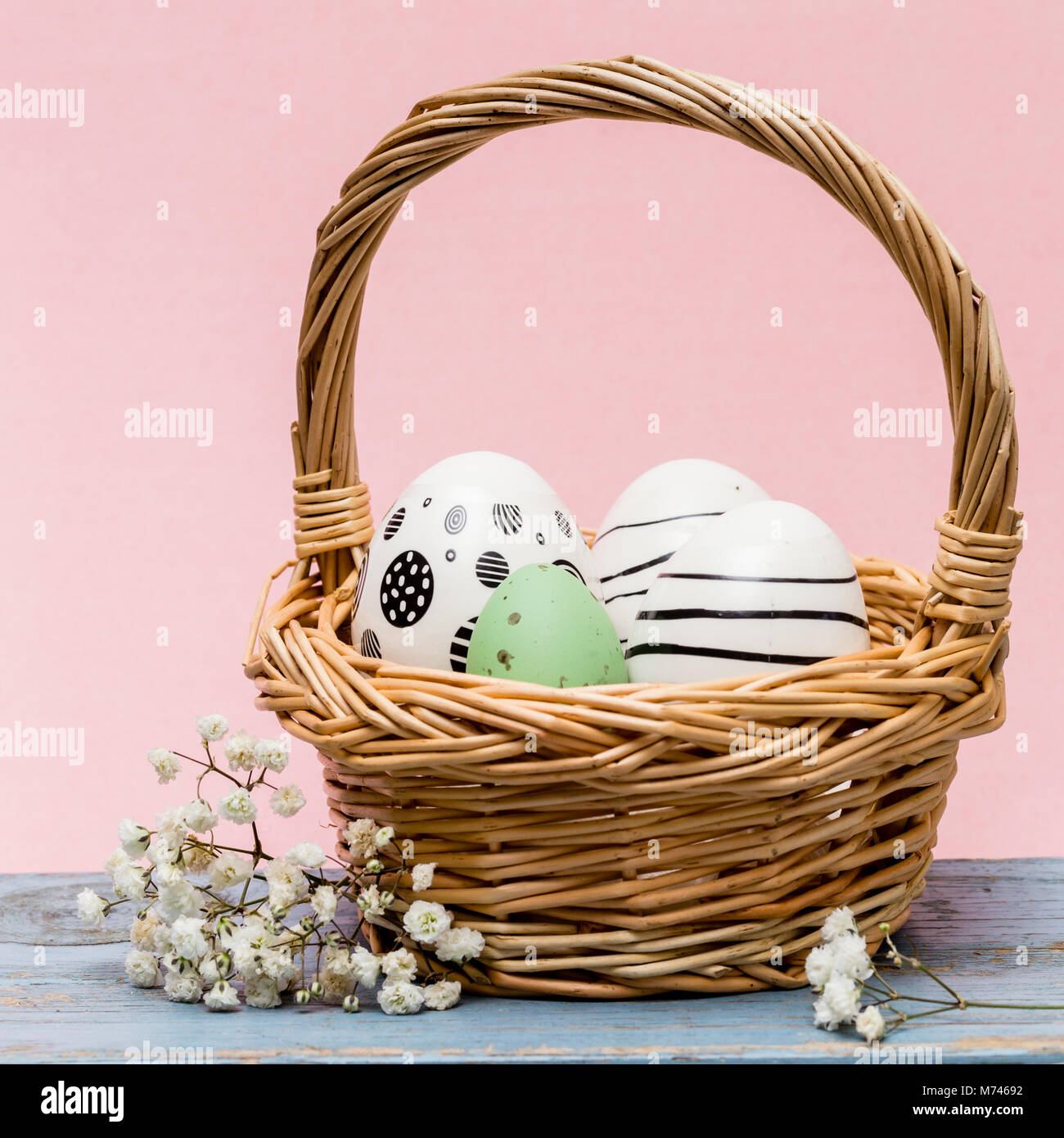 easter eggs in a basket with pink background Stock Photo - Alamy
