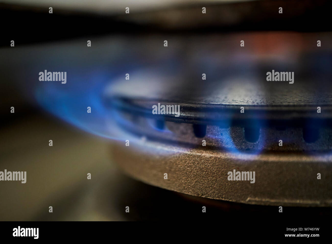 gas ring burning on kitchen hob using natural piped gas supply in the