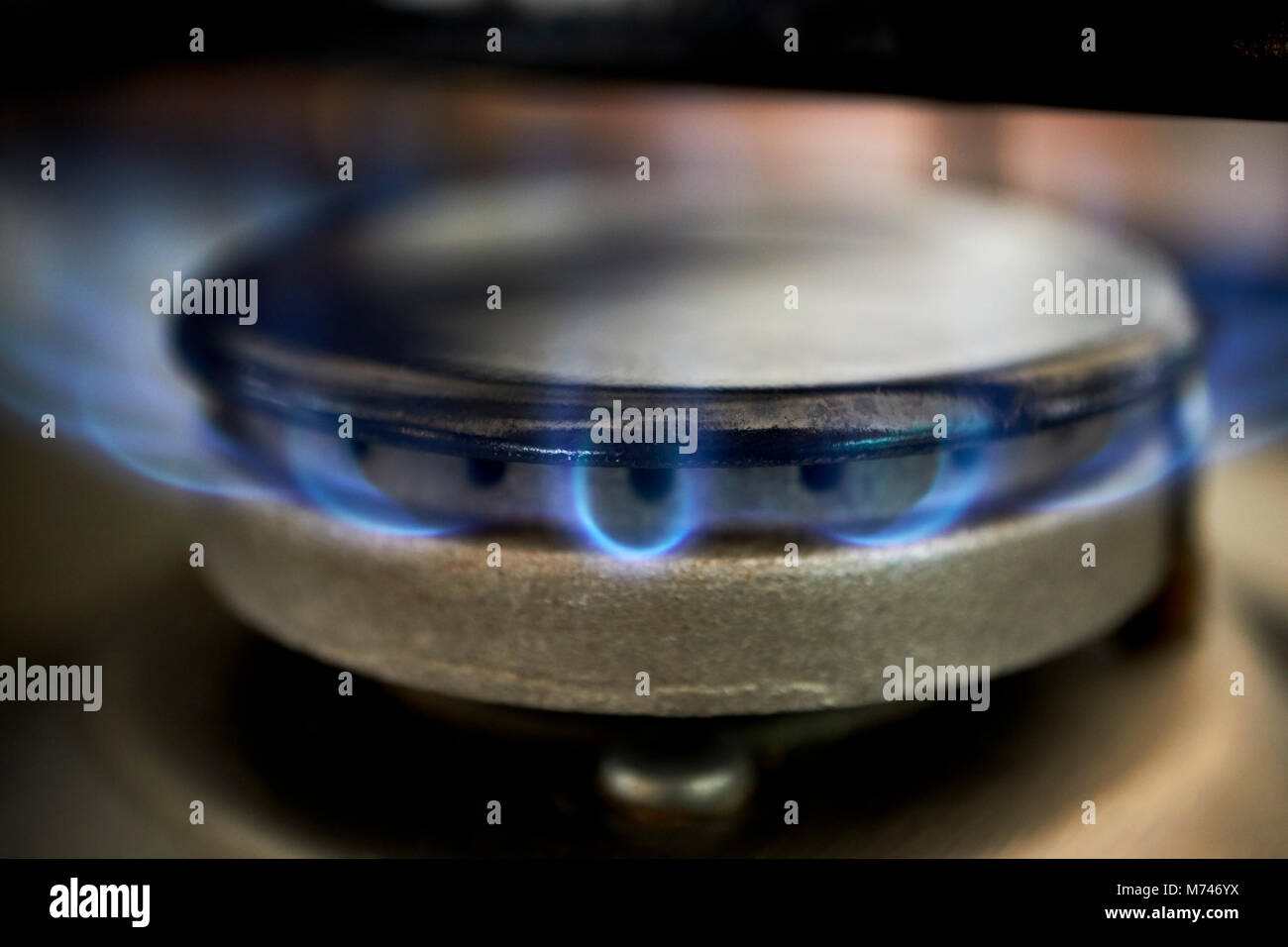 gas ring burning on kitchen hob using natural piped gas supply in the