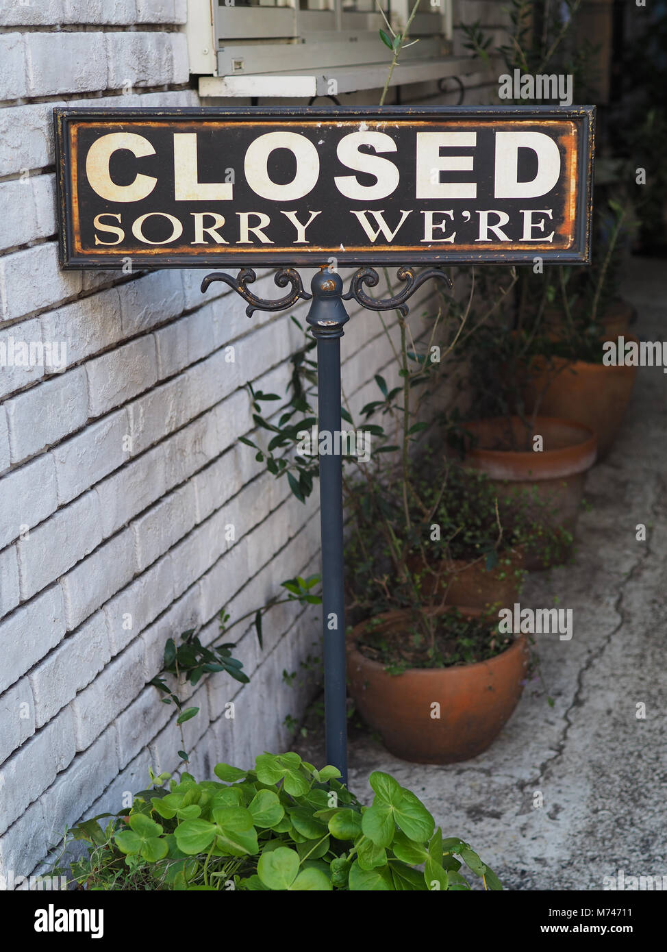 Authentic and cute ole’ Sorry We’re Closed sign. Stock Photo