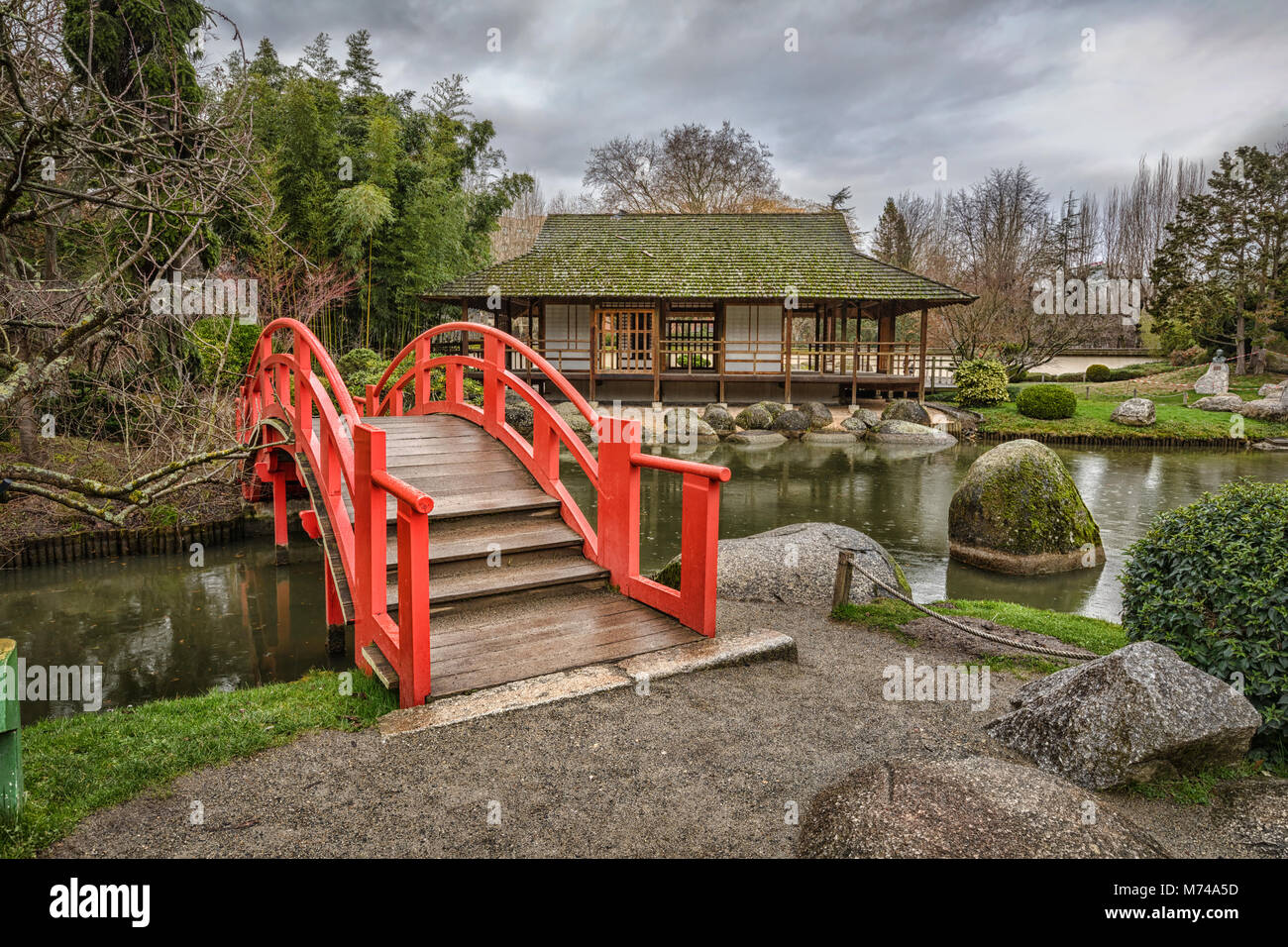 Red arch bridge in public Japanese garden in Toulouse, France Stock Photo