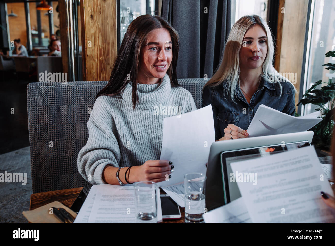 two young beautiful women at a business meeting in a cafe Stock Photo ...
