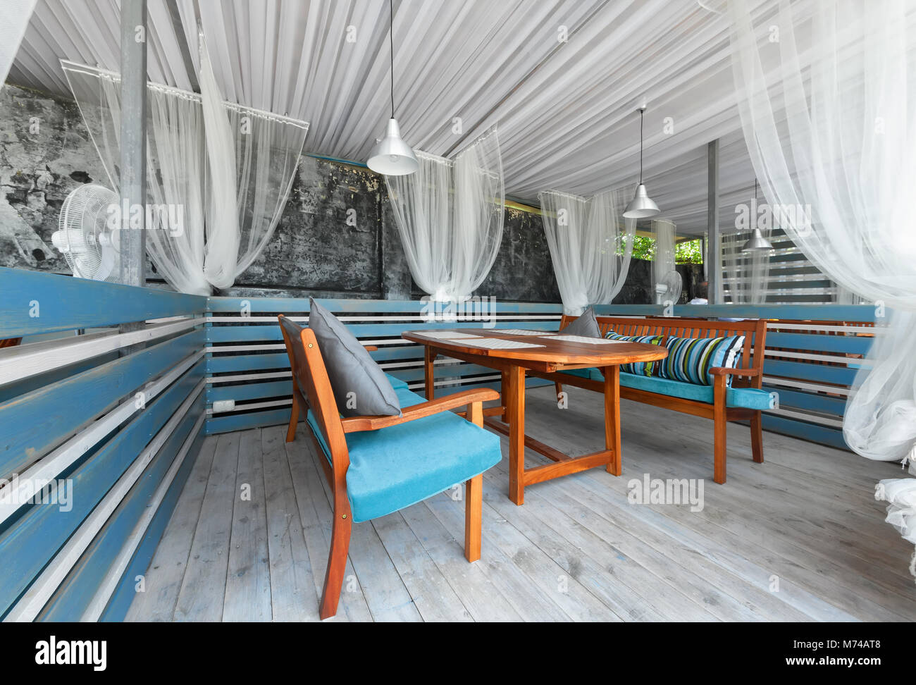 MOSCOW - JULY 2014: Interior of stylish Mediterranean cuisine Italian restaurant - 'SILLYCAT'. Covered veranda in a nautical style. Cabin with a table Stock Photo